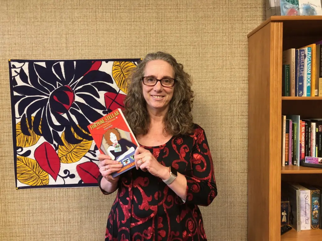 Christiana Gaudet poses with a copy of her book, Tarot Topics.